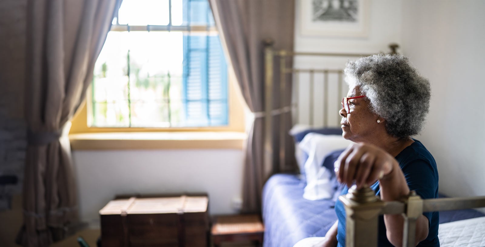 Woman sitting on bed
