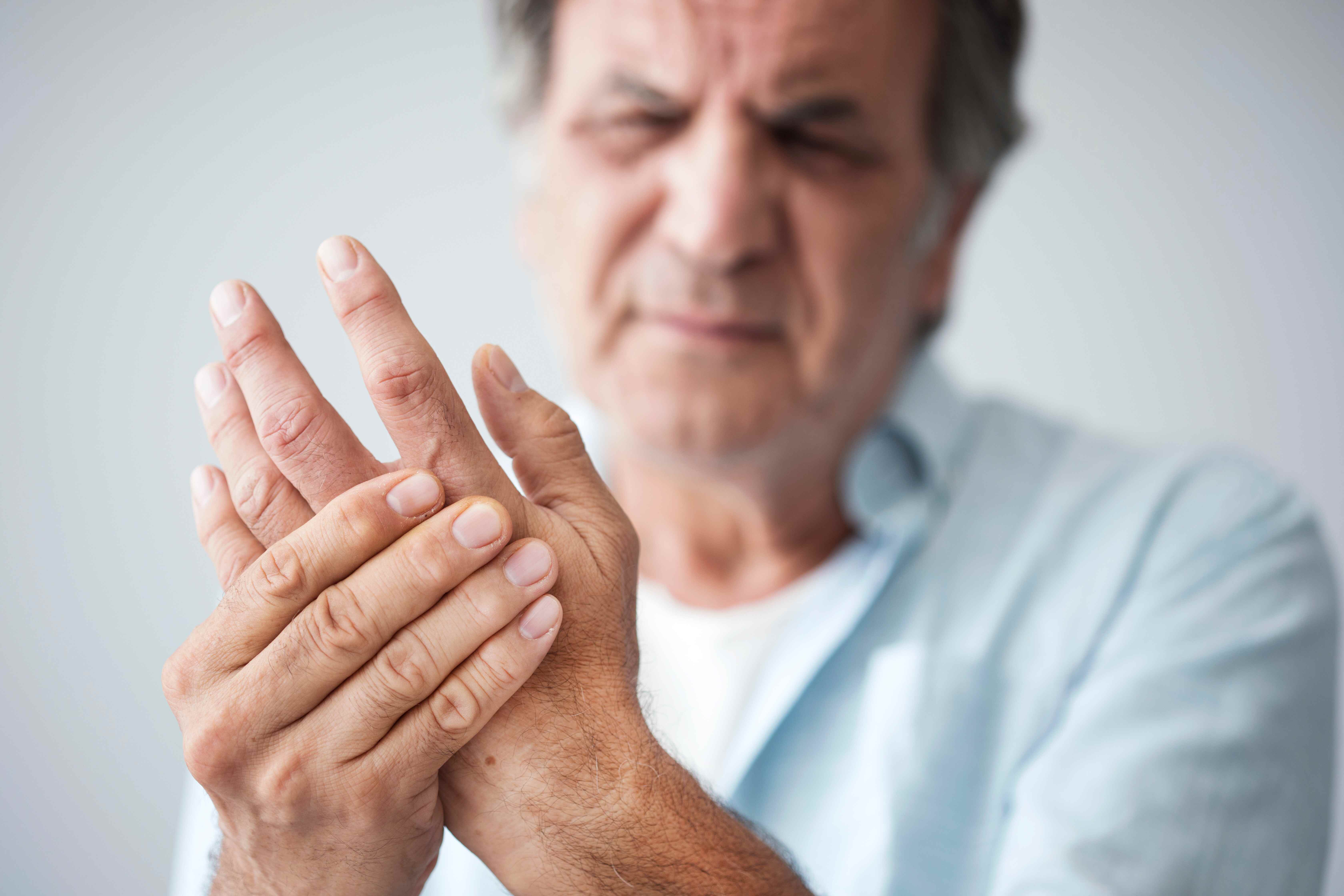 man holding hand in pain