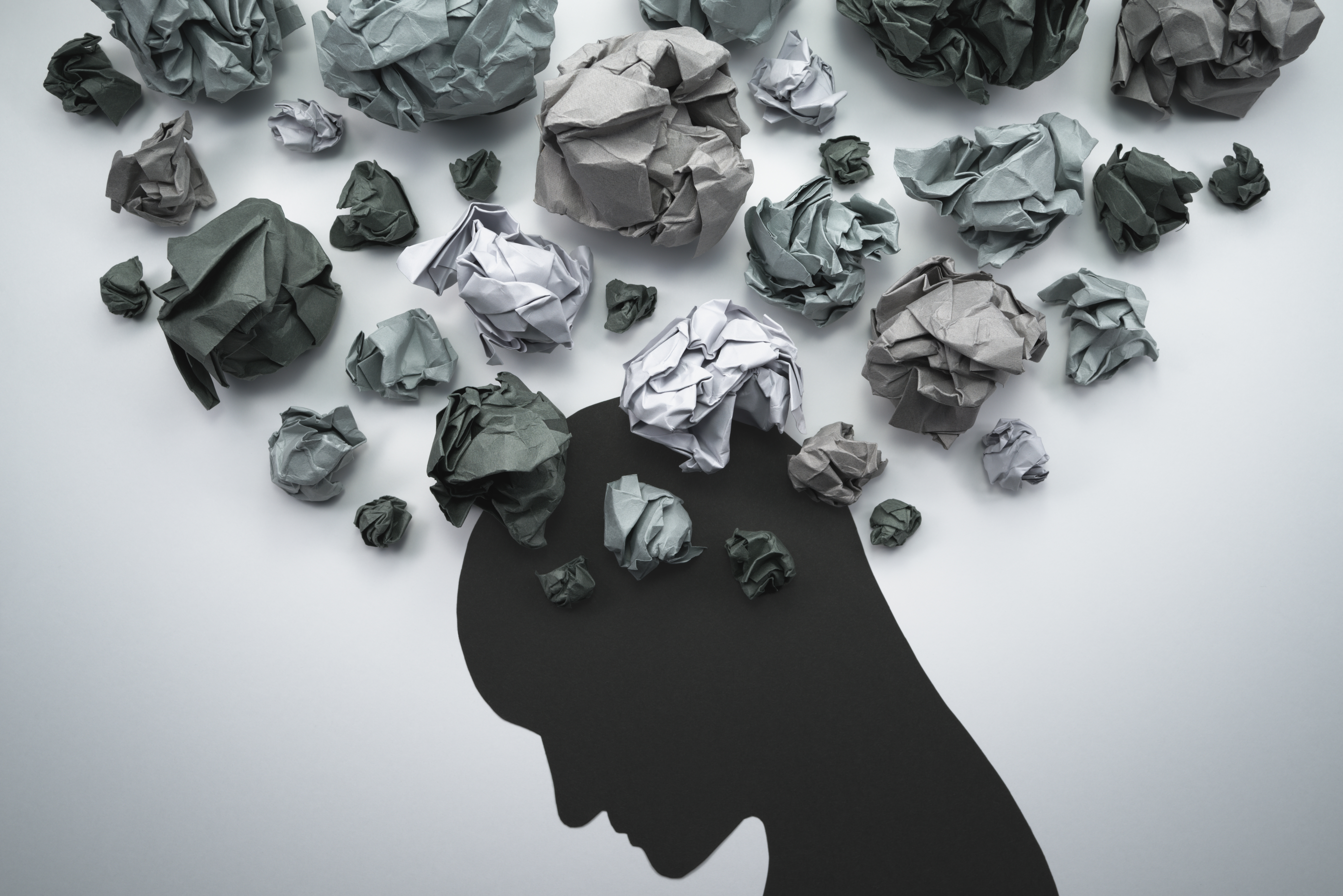 paper head with crumpled paper balls above