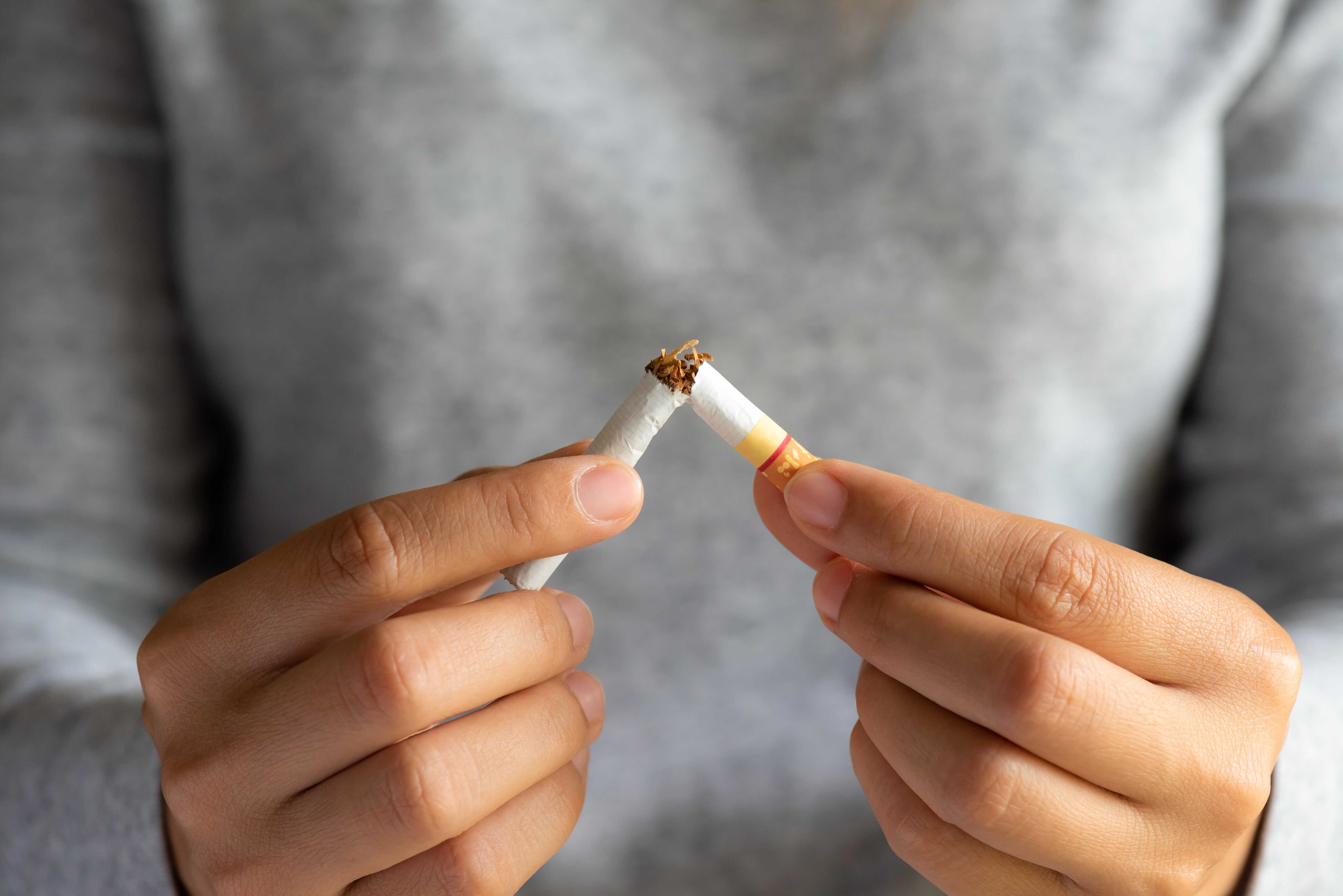 hands breaking cigarette